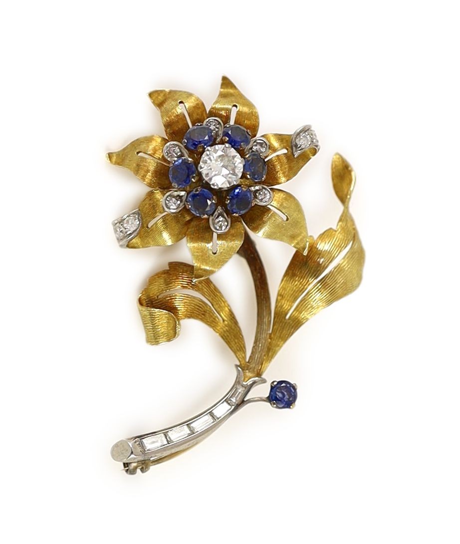 A textured gold, sapphire and diamond floral spray brooch